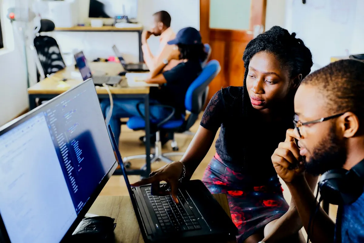Two developers reviewing code together at one screen