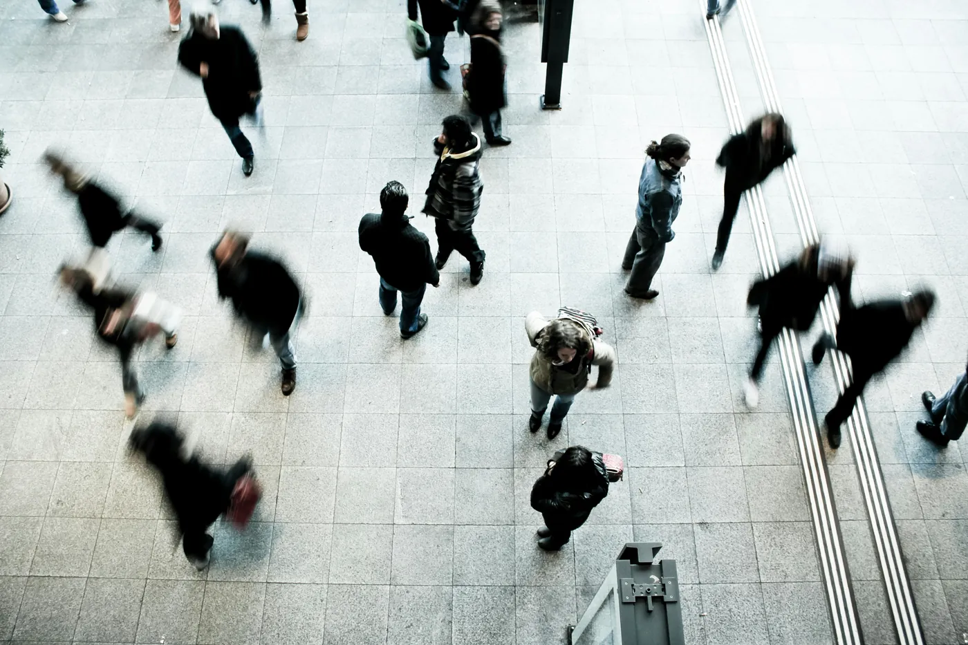 A public plaza seen from above, people crossing in every direction