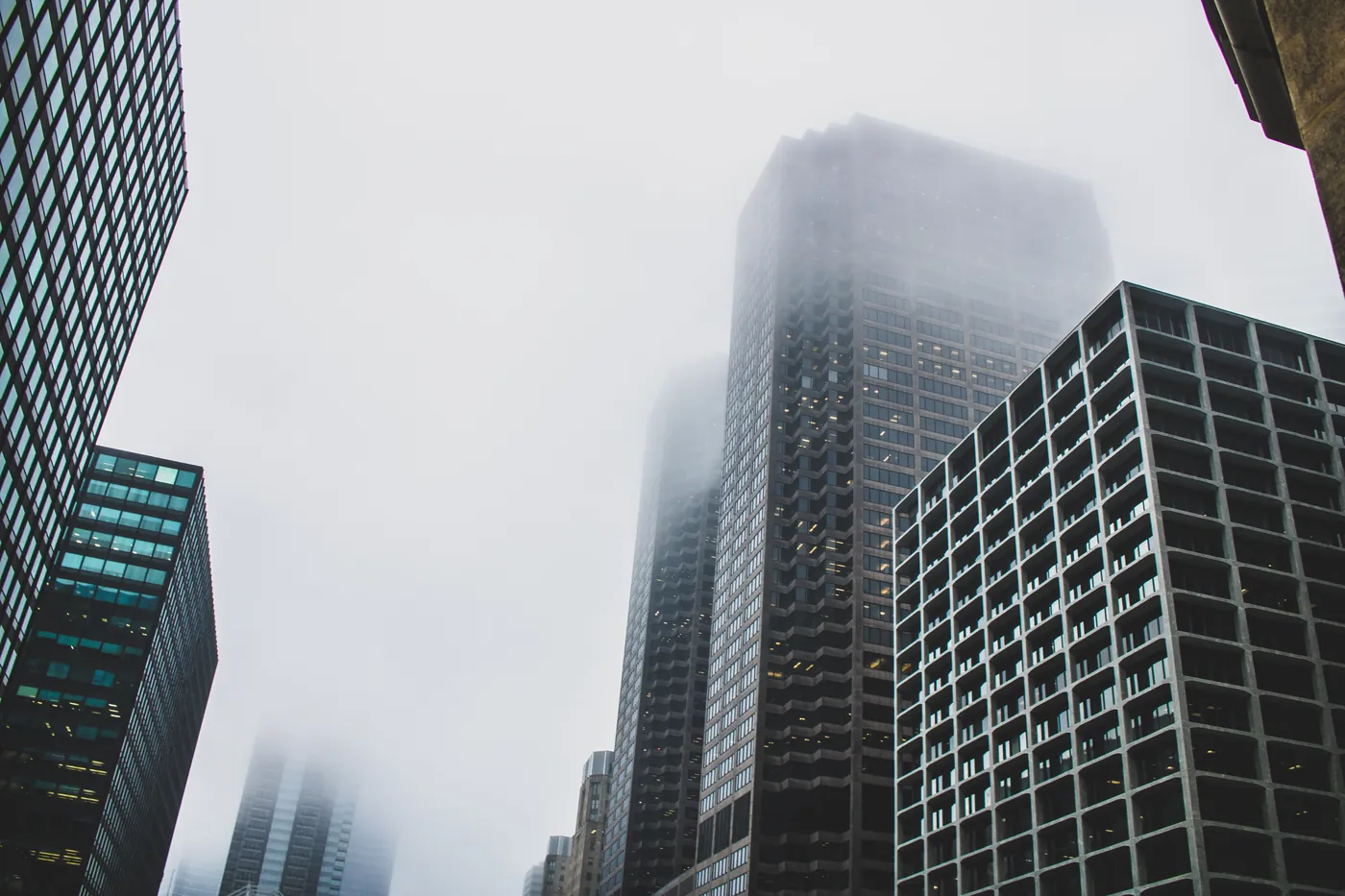 City towers with their upper floors disappearing into fog