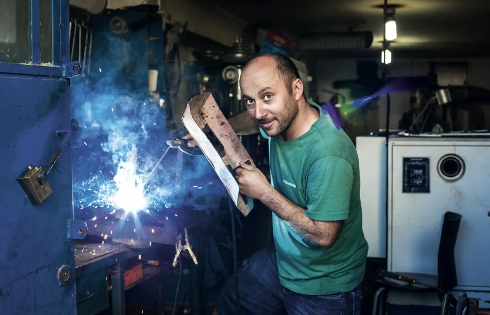 A welder at work amid sparks
